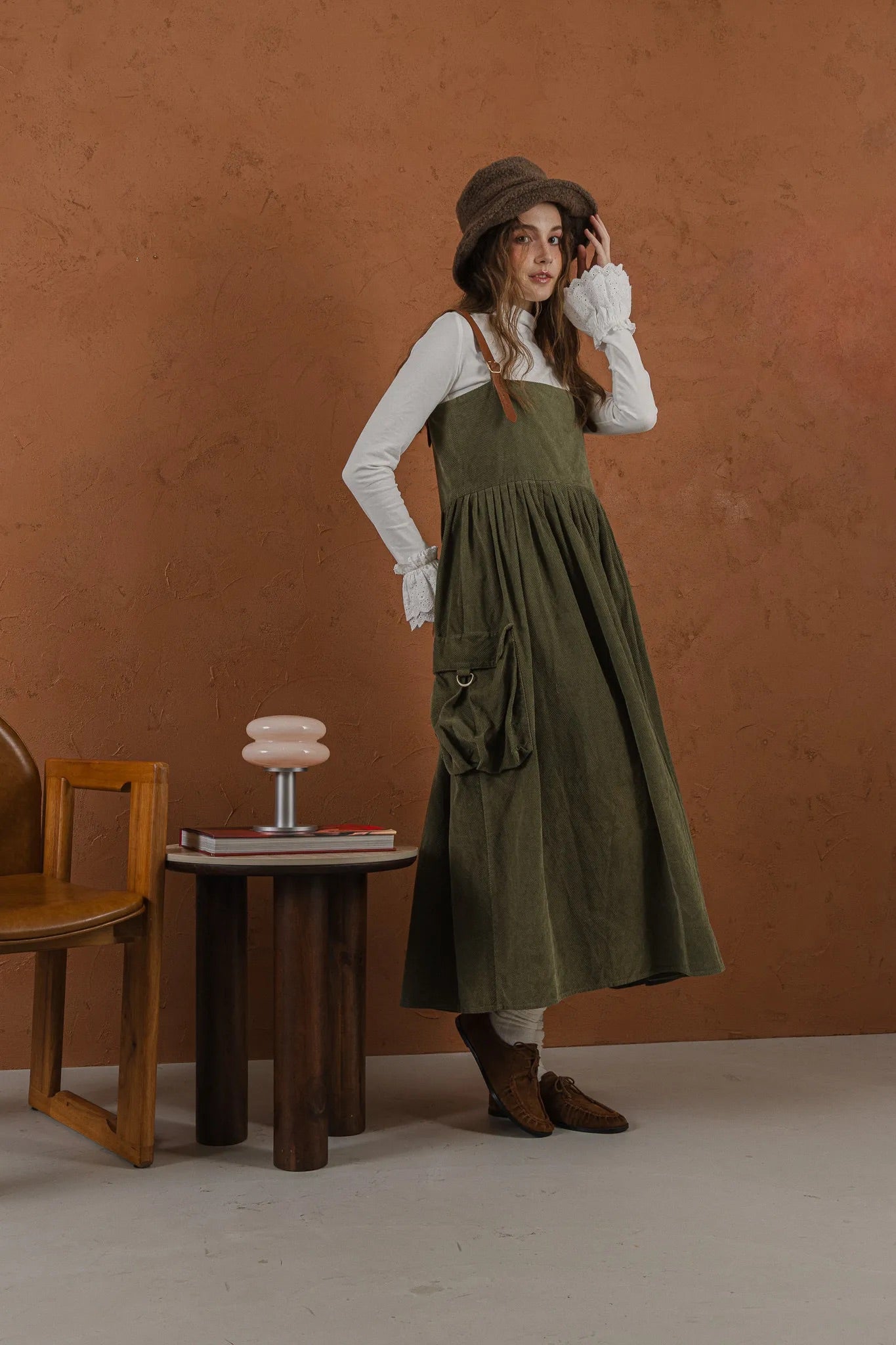 軍綠絨面口袋洋裝，日本純棉立體口袋與小羊皮肩帶高腰抽皺，展現優雅率性輪廓。