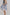 模特兒穿著三層雙拉鏈蕾絲洋裝「卡其格紋」，卡其色格紋布與日本蕾絲層層拼接，搭配前胸雙拉鍊與兩側口袋設計，呈現溫潤又俐落的廓形。